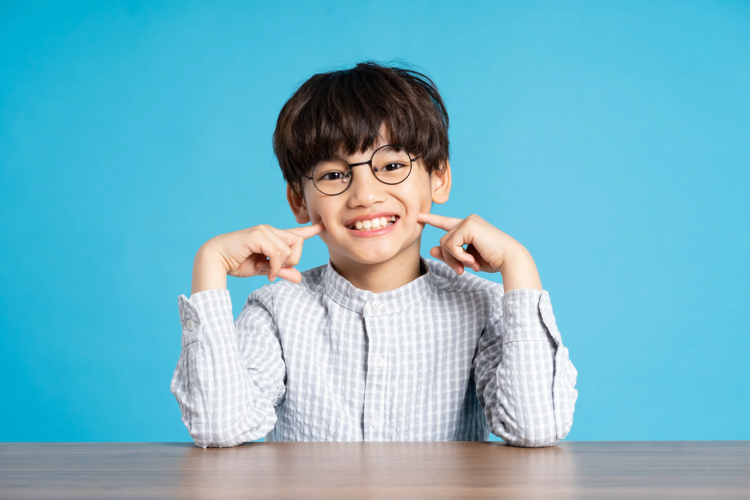 portrait school boy sitting studying blue background min